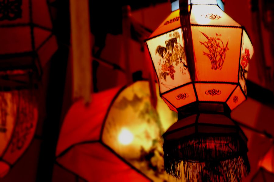 Three red and gold Chinese lanterns